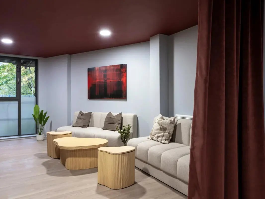 Light gray sofas art and wood tables living room at Dunaskin Mill in Glasgow Student Accommodation