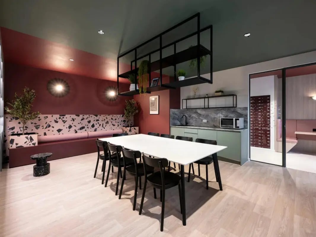 Dining table chairs bench kitchen and plants living area at Dunaskin Mill in Glasgow Student Accommodation