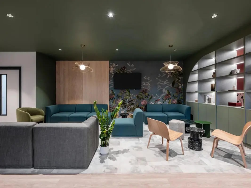 Modern lounge with sofas chairs and shelving living room at Dunaskin Mill in Glasgow Student Accommodation