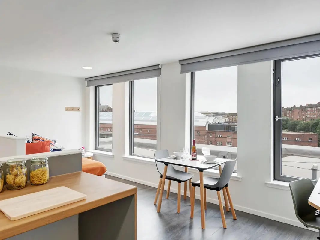 Dining table with chairs and jars living area at Dunaskin Mill in Glasgow Student Accommodation