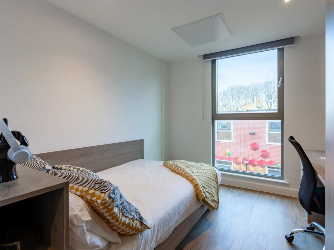 Bed desk headphones window bedroom at Pavilion Point in Brighton Student Accommodation