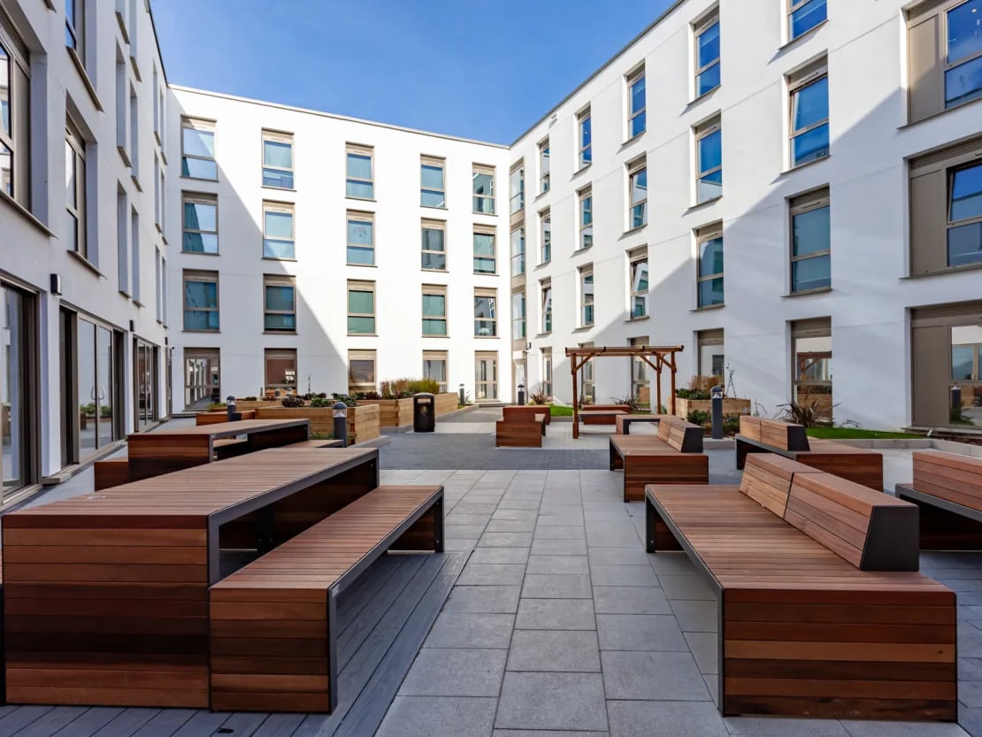 Wooden benches and tables courtyard exterior at Pavilion Point in Brighton Student Accommodation