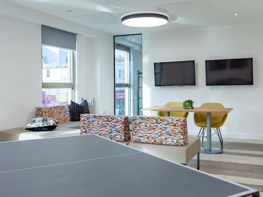Ping pong table two TVs and table living room at Pavilion Point in Brighton Student Accommodation