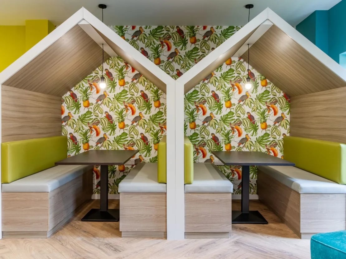 Booth seating with tropical wallpaper study area at Gulson Gardens in Coventry Student Accommodation