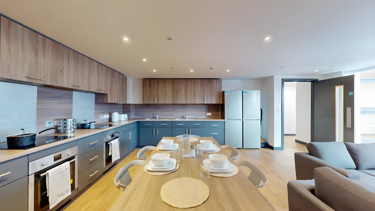 Modern kitchen with dining table and fridges kitchen at Innovo House in Liverpool Student Accommodation
