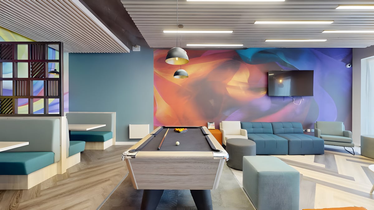 Pool table, booths, and sofa in lounge at Innovo House in Liverpool Student Accommodation