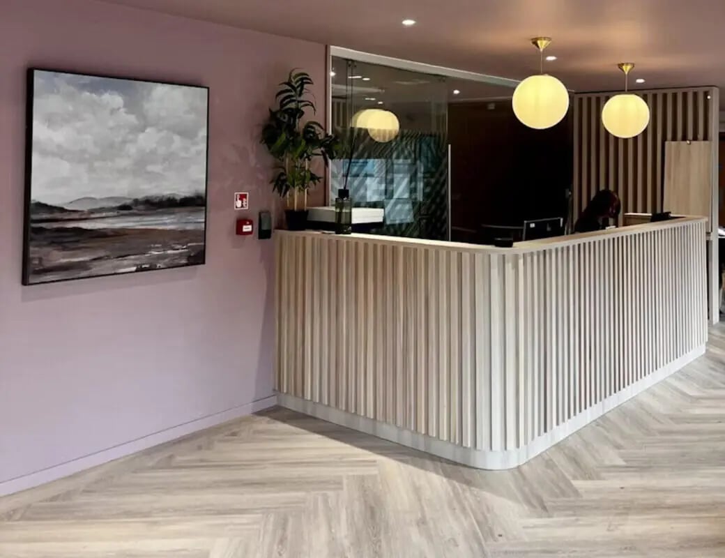 Modern reception desk with abstract art reception area at Byrom Point in Liverpool Student Accommodation
