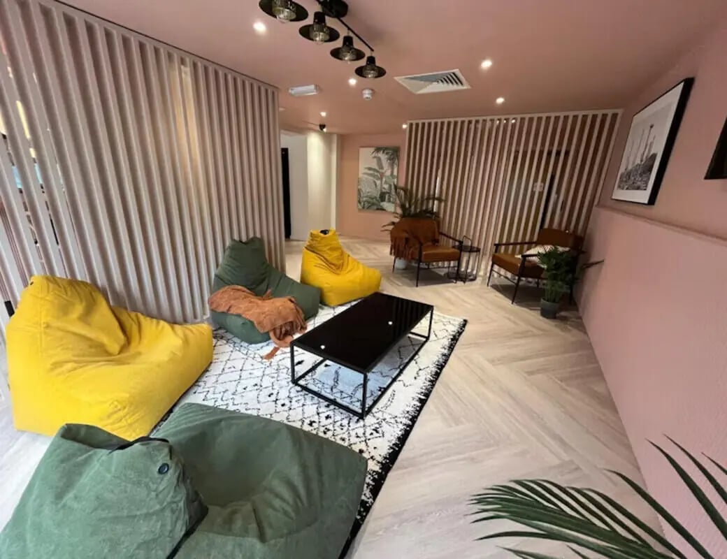 Beanbag chairs coffee table patterned rug living room at Byrom Point in Liverpool Student Accommodation