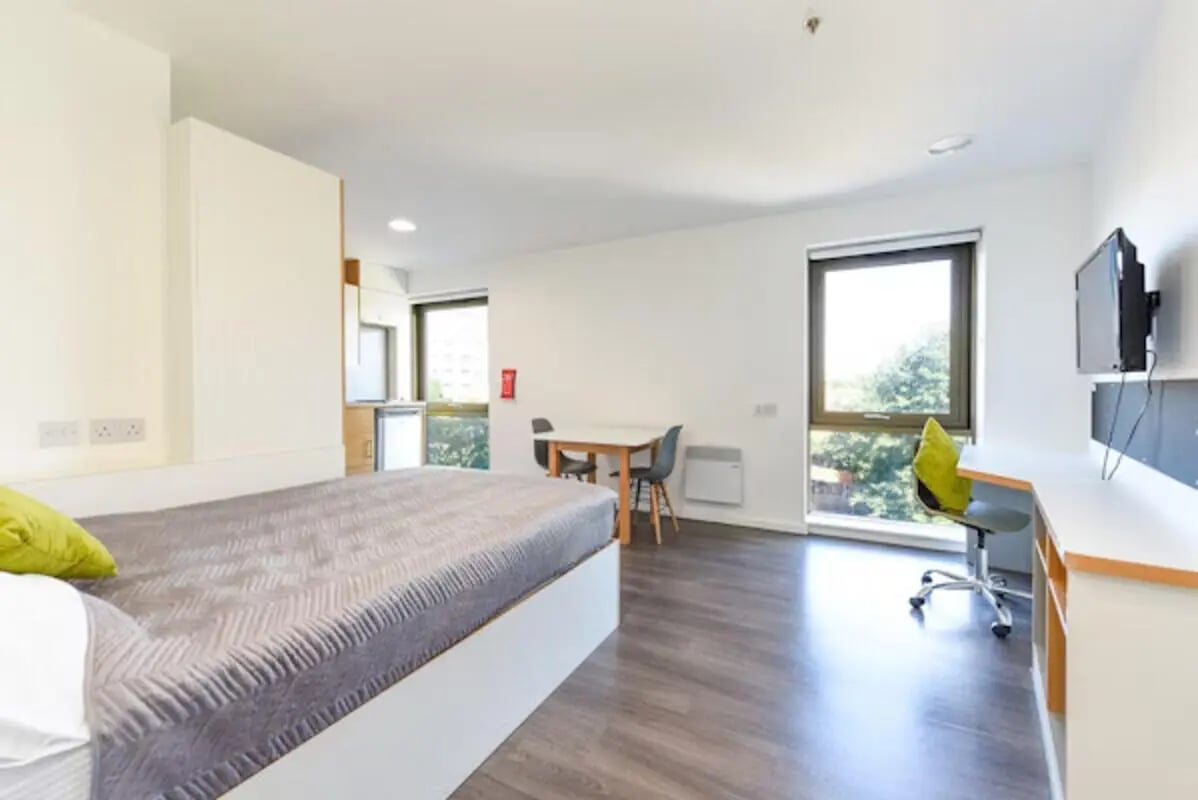 Bed desk TV table and chairs studio apartment at Byrom Point in Liverpool Student Accommodation