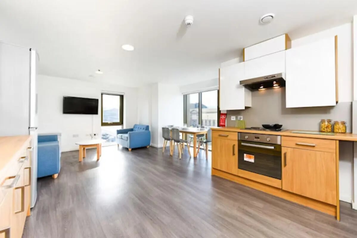 Modern kitchen and living area with chairs living room at Byrom Point in Liverpool Student Accommodation