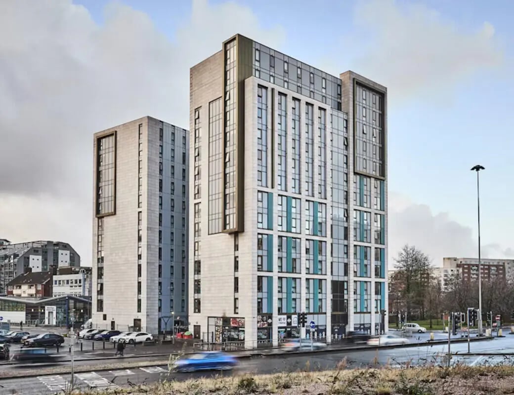 Modern student accommodation towers with cars and street Exterior at Byrom Point in Liverpool Student Accommodation