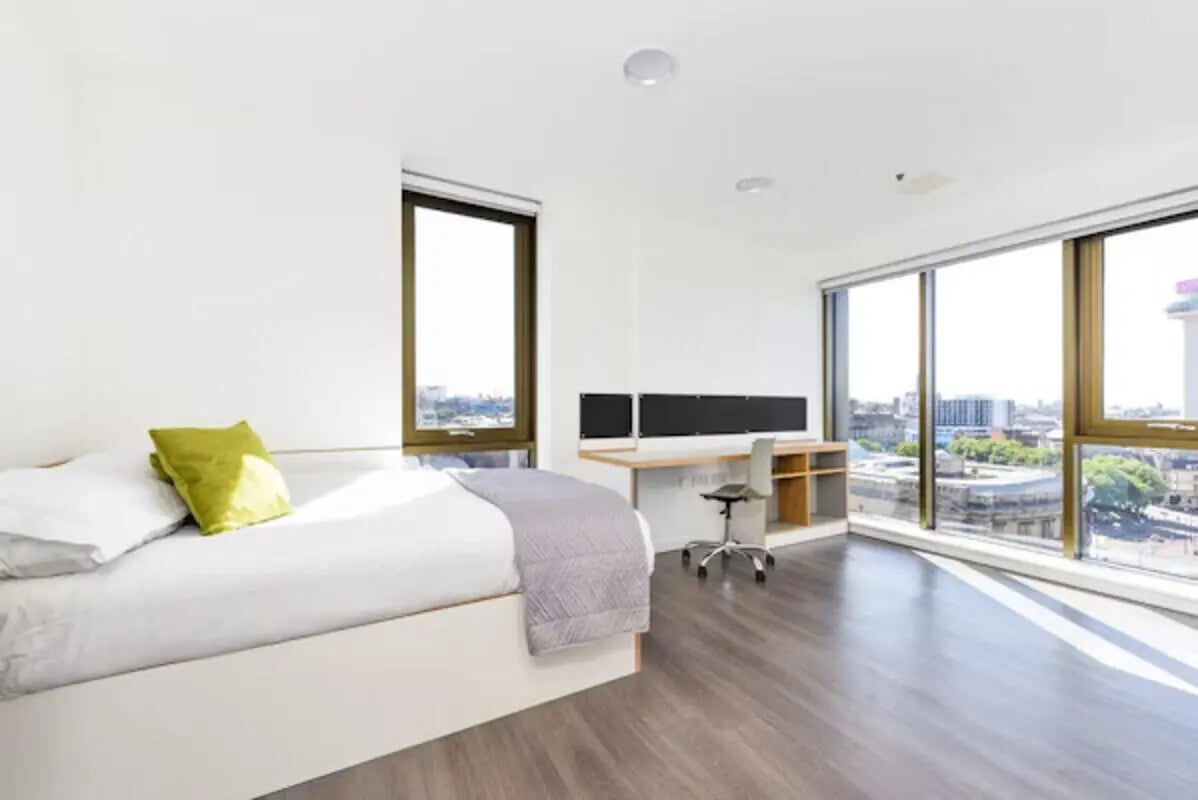 Bed desk chair with city view bedroom at Byrom Point in Liverpool Student Accommodation