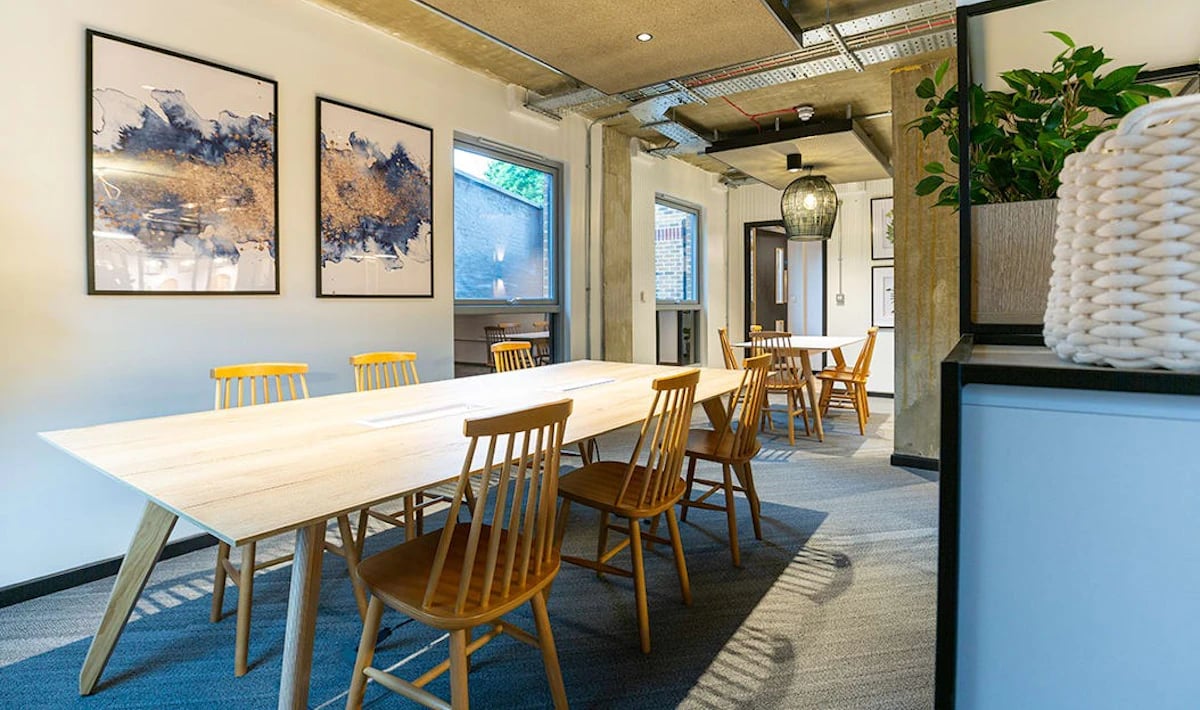 Long table with chairs art walls communal area at Westcombe House in London Student Accommodation