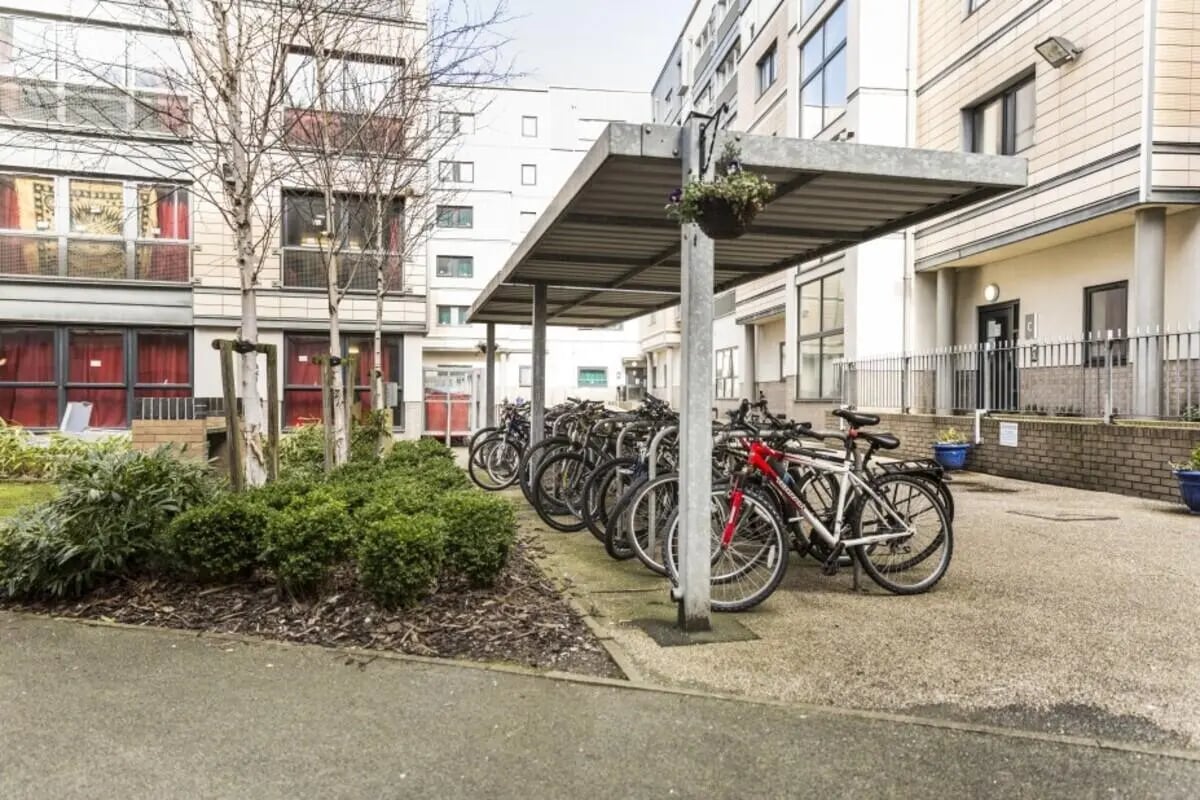 Bicycles parked under shelter by apartment building Exterior at Albert Court in Liverpool Student Accommodation