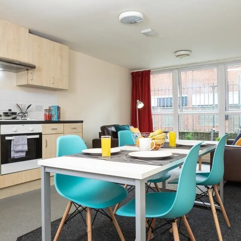 Dining table chairs kitchen lounge living area at Albert Court in Liverpool Student Accommodation