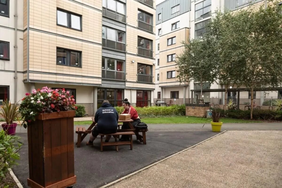 Students at picnic table exterior student accommodation exterior at Albert Court in Liverpool Student Accommodation