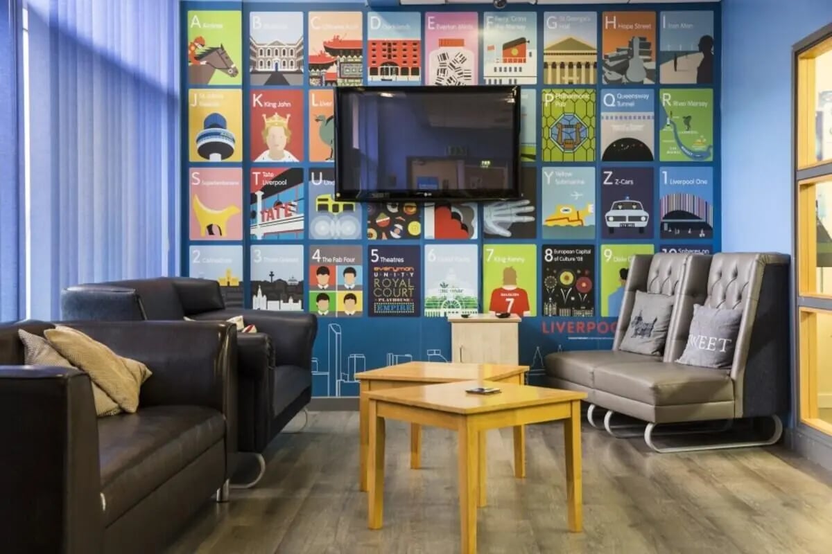 Sofas tables television colorful wall art living room at Albert Court in Liverpool Student Accommodation