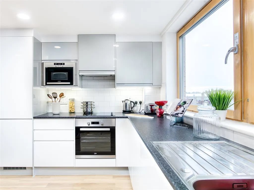 Modern white kitchen with microwave oven and oven kitchen at New Orient House in London Student Accommodation