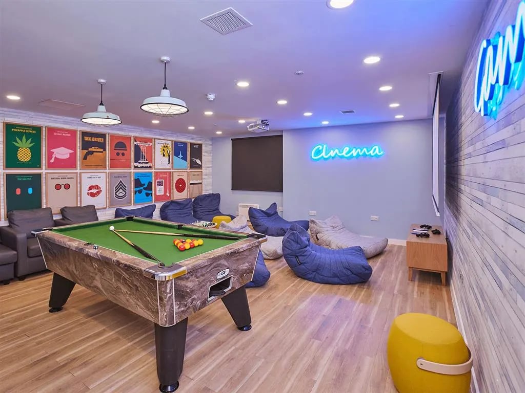 Pool table beanbags and cinema sign lounge at New Orient House in London Student Accommodation