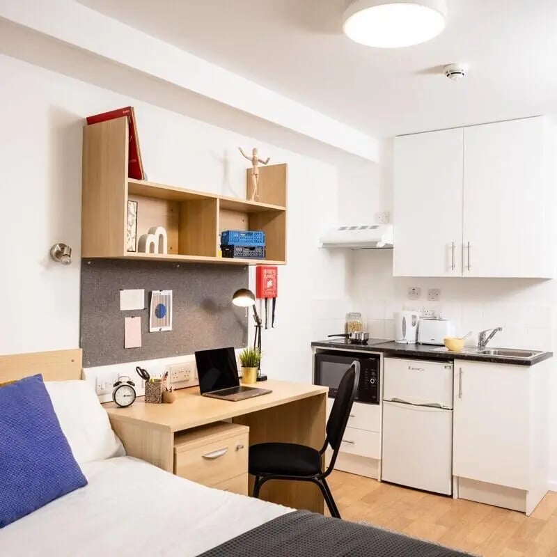Desk bed shelves kitchen and appliances studio apartment at Prince Consort Village in London Student Accommodation