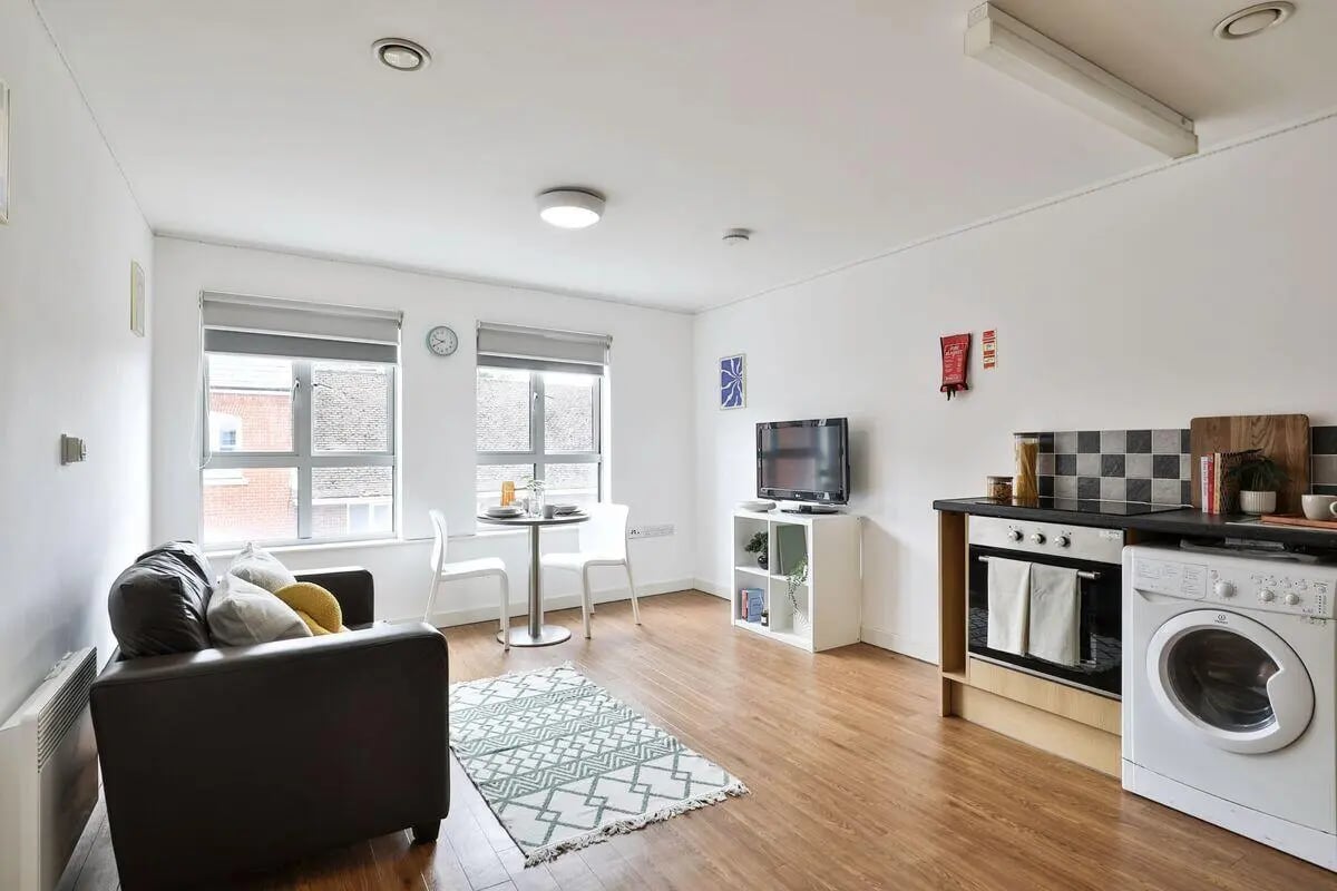 Sofa television dining table kitchen living room at Pavilion Court in Canterbury Student Accommodation