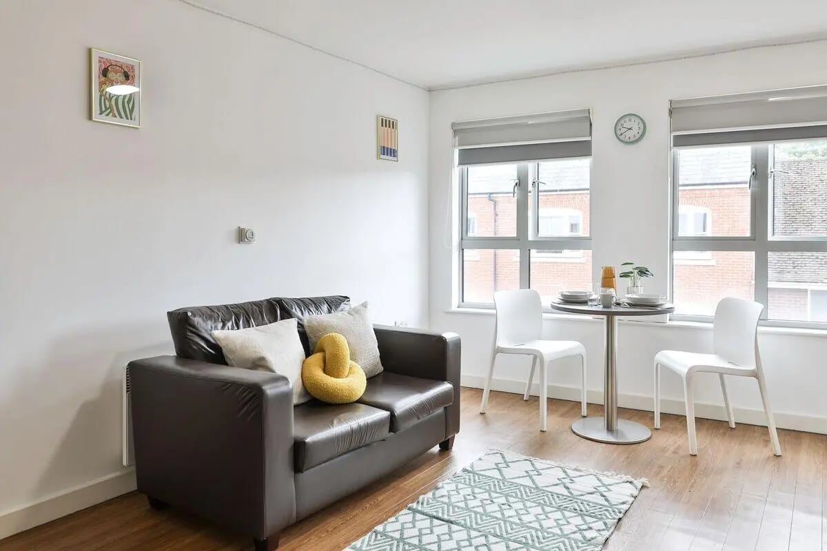 Brown couch and table with chairs living room at Pavilion Court in Canterbury Student Accommodation