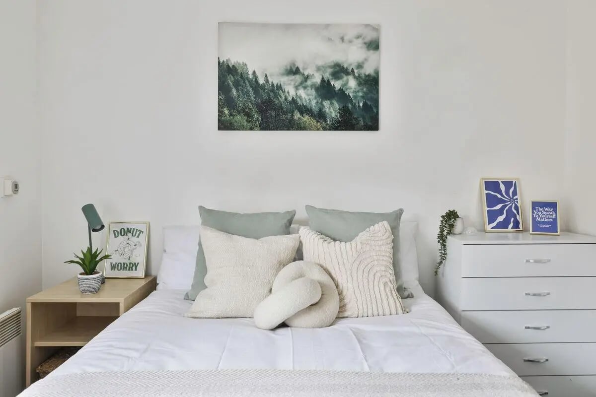 Bed with pillows art and dresser bedroom at Pavilion Court in Canterbury Student Accommodation