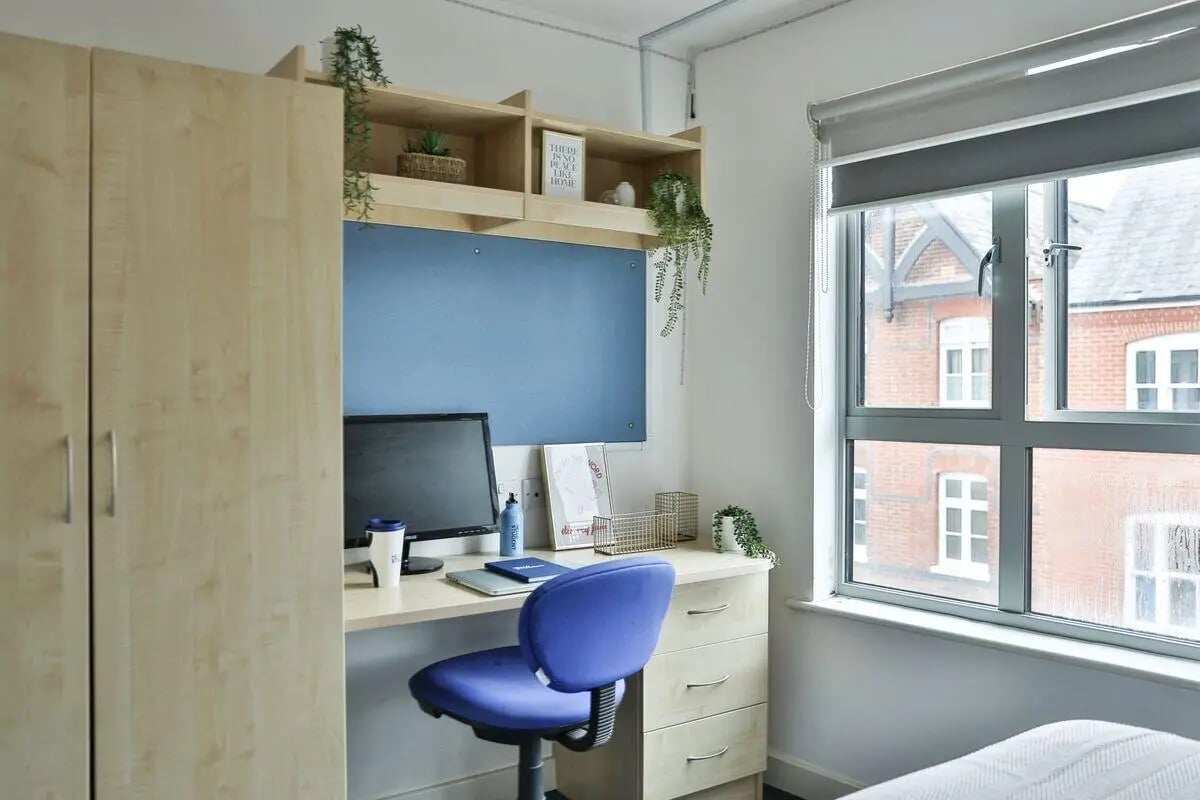 Wardrobe desk chair computer and window view study area at Pavilion Court in Canterbury Student Accommodation