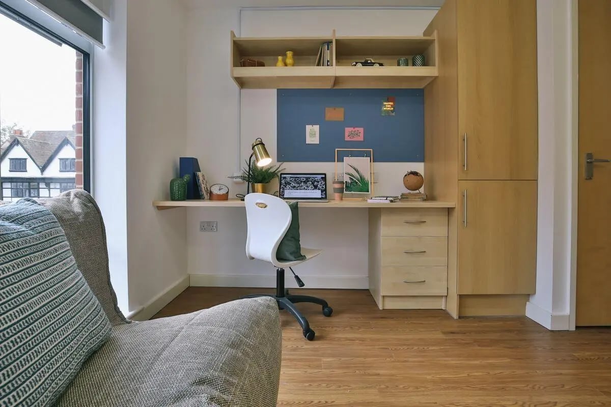 Desk with laptop chair and shelves study area at Pavilion Court in Canterbury Student Accommodation