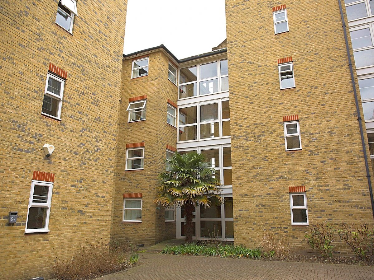 Yellow brick building with many windows exterior at Dean House in London Student Accommodation