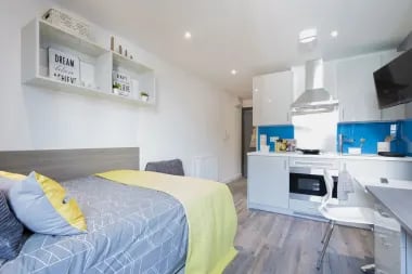 Studio apartment bed kitchen and desk at Glendower House in Cardiff Student Accommodation