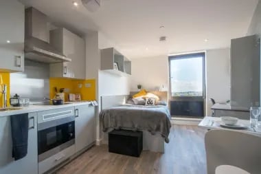Modern studio apartment with bed and kitchen bedroom at Glendower House in Cardiff Student Accommodation