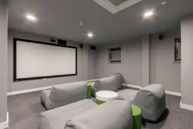 Comfortable beanbags surround coffee tables cinema room at Glendower House in Cardiff Student Accommodation