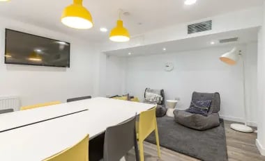 Table chairs television beanbags lounge area at Glendower House in Cardiff Student Accommodation