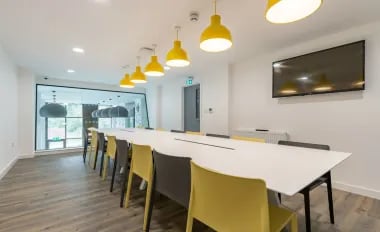 Long table chairs and television study area at Glendower House in Cardiff Student Accommodation