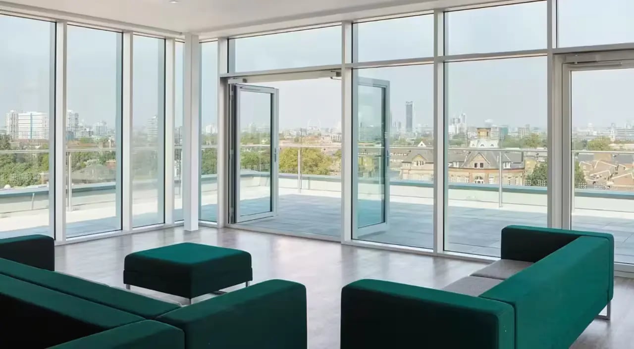 Modern sofas ottoman with large windows living room at Townhall Camberwell in London Student Accommodation