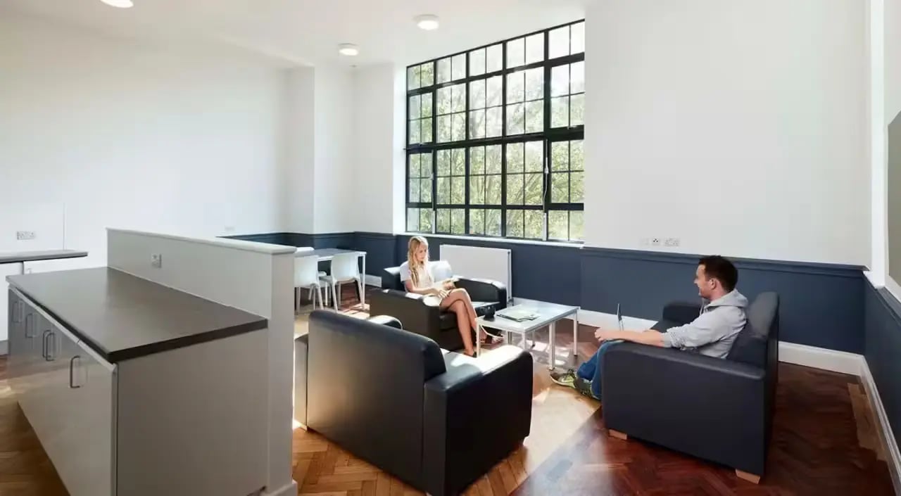 Two people relaxing in a communal living room at Townhall Camberwell in London Student Accommodation