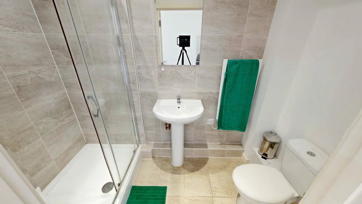 Shower sink toilet green towel bathroom at St Marks Court - Nottingham in Nottingham Student Accommodation