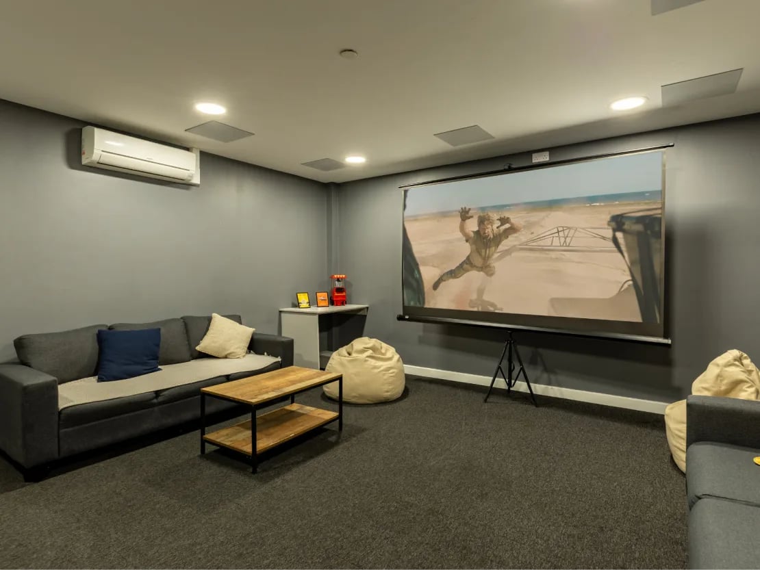 Sofa projector screen beanbags and coffee table living room at Radford Mill in Nottingham Student Accommodation