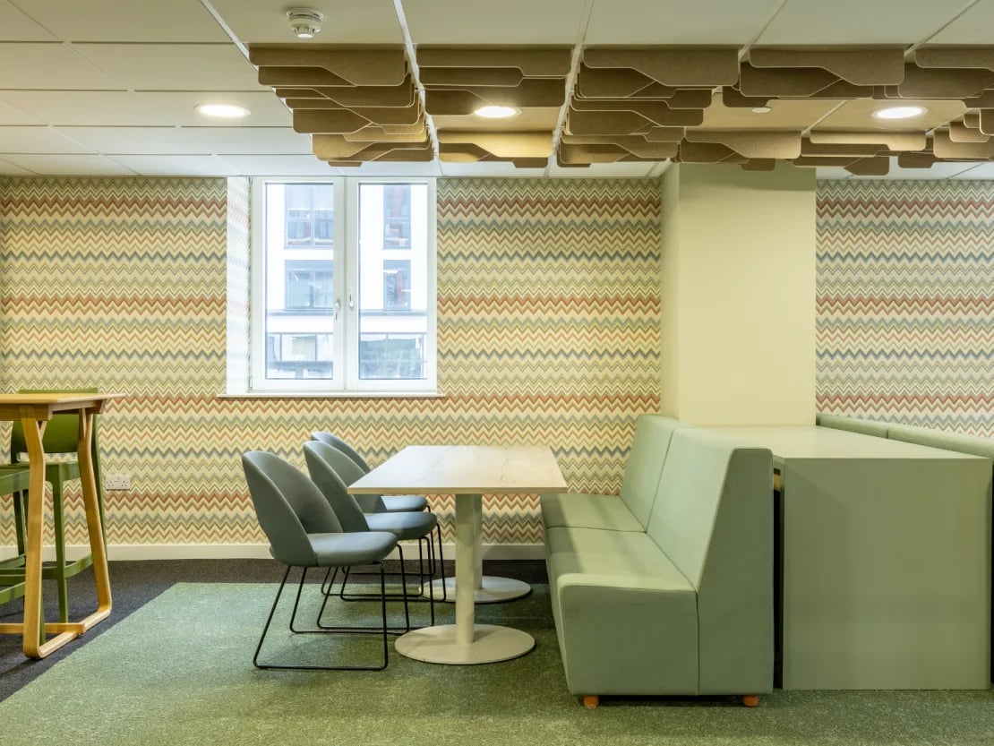 Table chairs sofa patterned wall common area at Radford Mill in Nottingham Student Accommodation