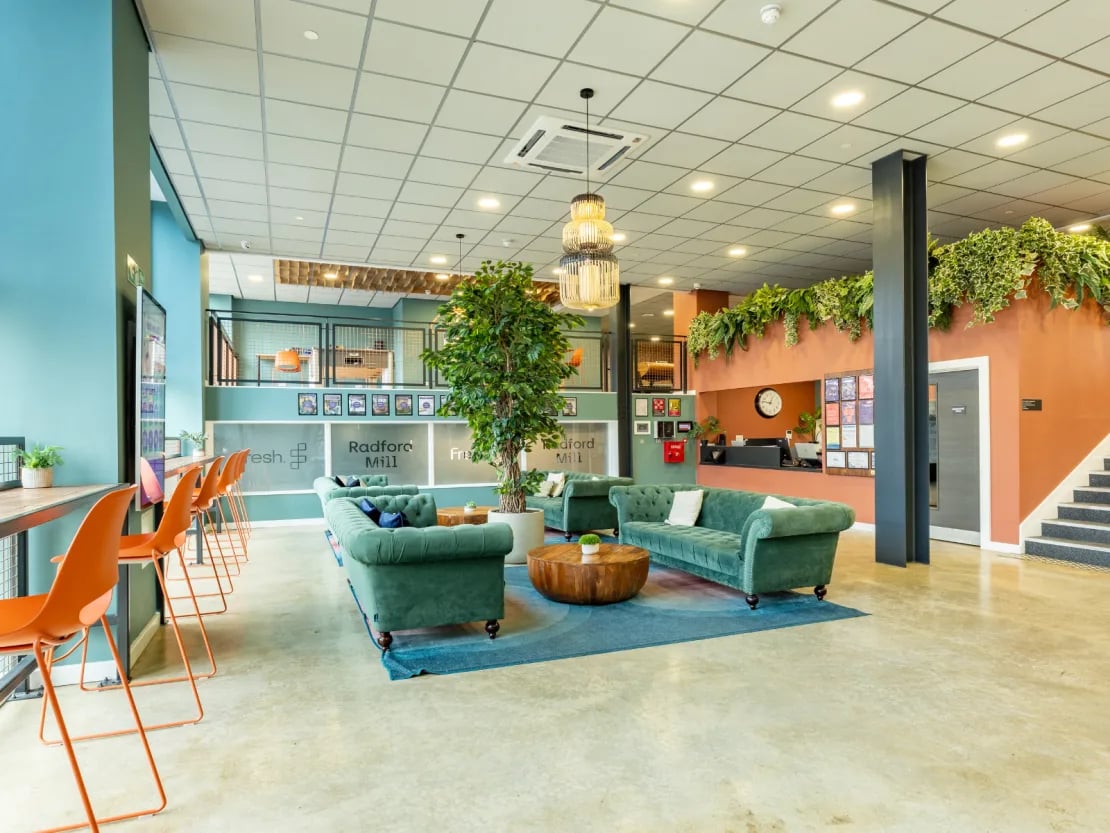 Green sofas and orange chairs communal area at Radford Mill in Nottingham Student Accommodation