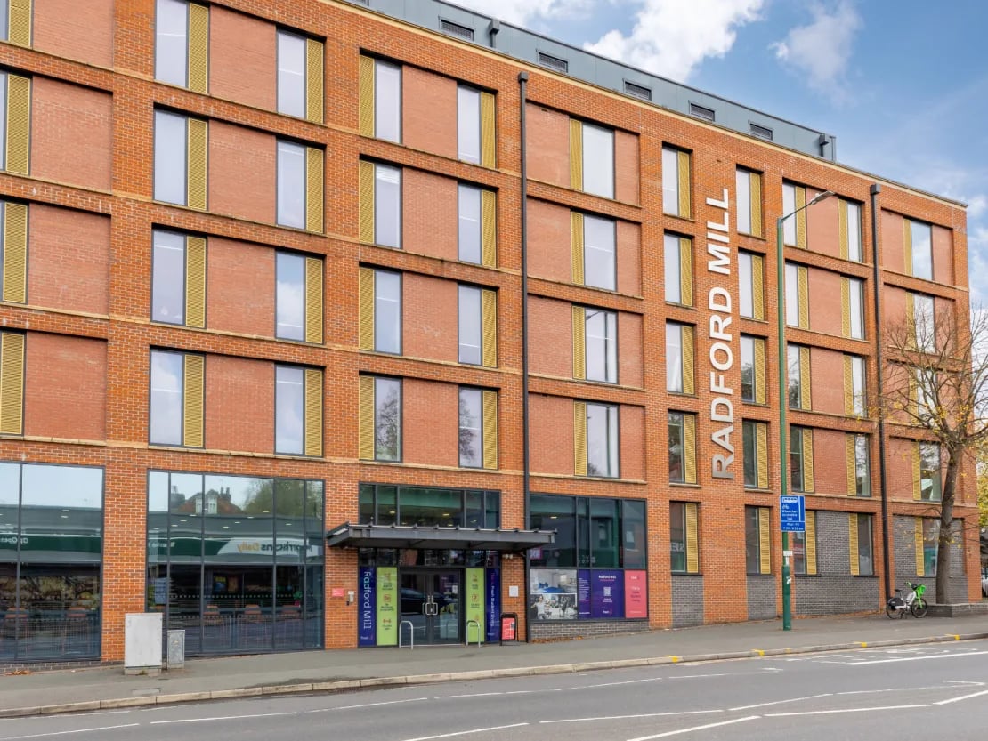 Red brick building with Radford Mill sign exterior at Radford Mill in Nottingham Student Accommodation