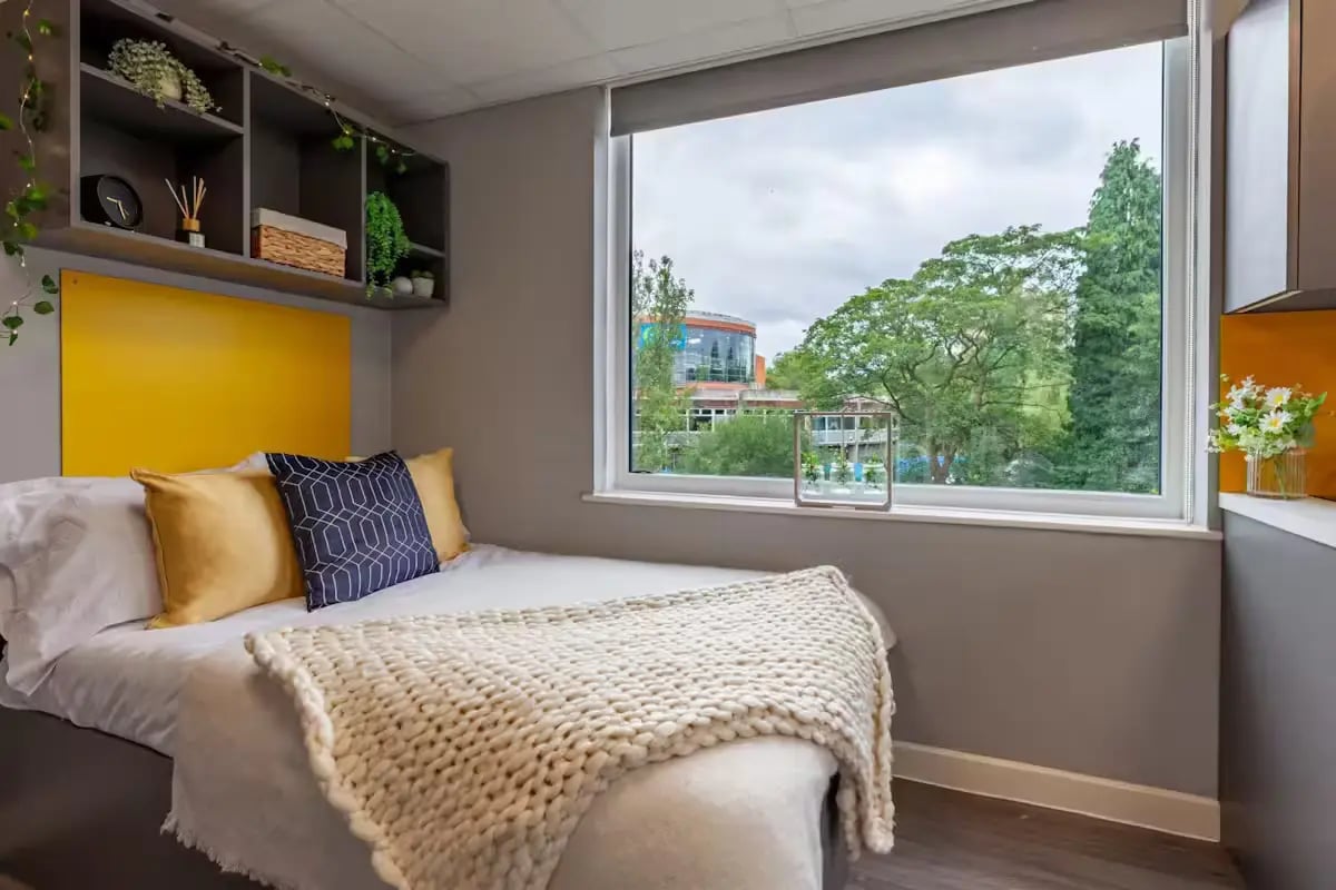 Bed with pillows and shelves bedroom at Allen Court in Manchester Student Accommodation