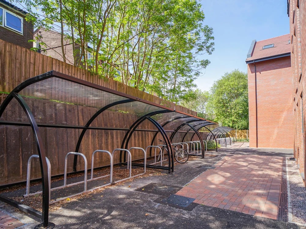 Covered bike racks and brick building exterior at Orme House in Newcastle Under Lyme Student Accommodation