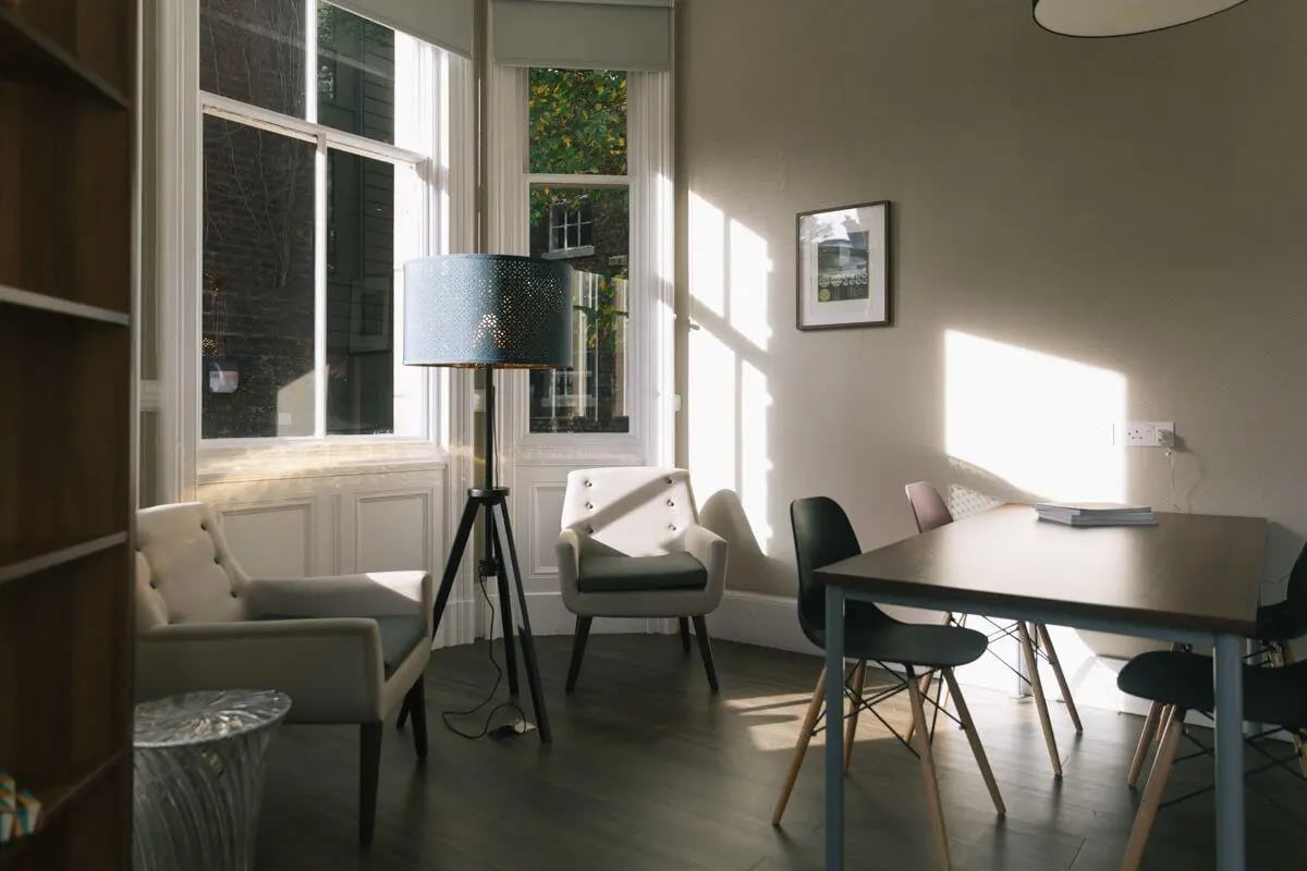 Chairs table lamp by window Living Room at The Hahnemann Building in Liverpool Student Accommodation