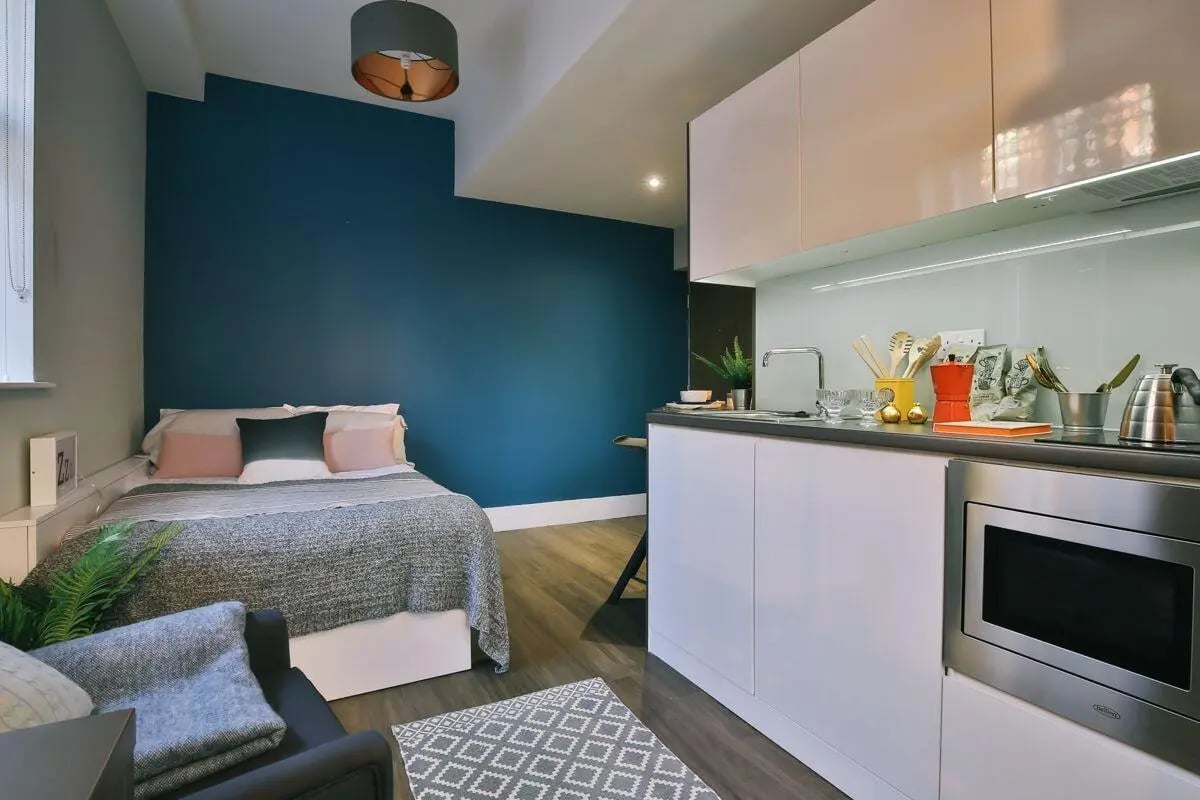 Bed sofa kitchen counter microwave studio apartment at The Hahnemann Building in Liverpool Student Accommodation