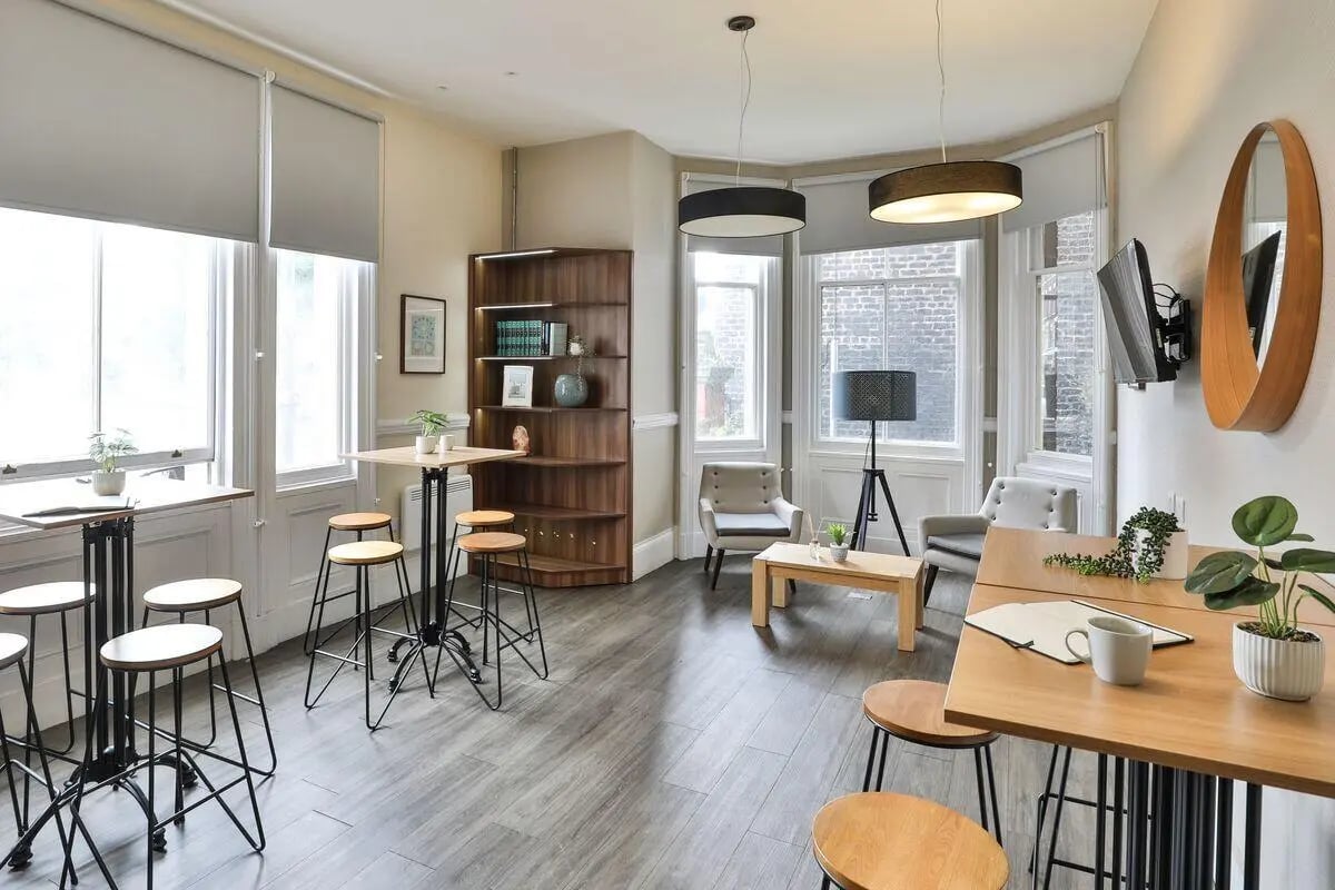 High tables bar stools coffee table chairs living room at The Hahnemann Building in Liverpool Student Accommodation