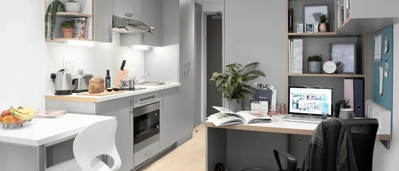 Kitchen study area with desk and laptop at Lace Market Studios in Nottingham Student Accommodation