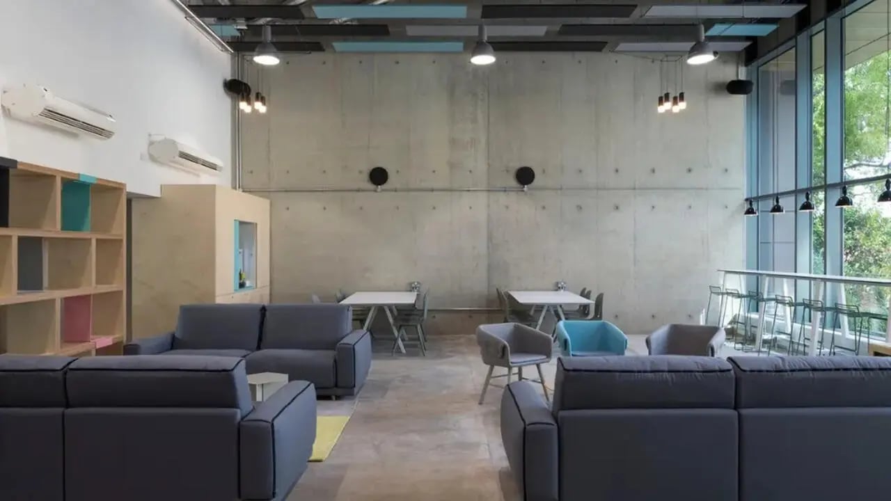 Sofas tables chairs shelving lounge area at Lace Market Studios in Nottingham Student Accommodation
