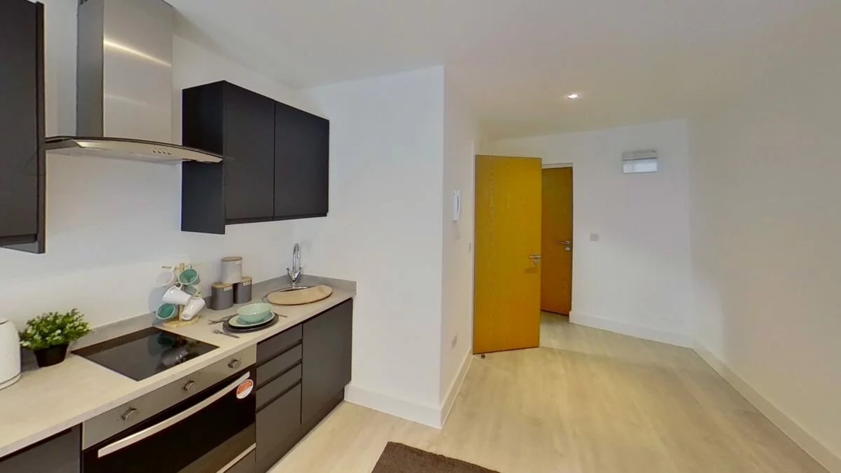Modern kitchen with dark cabinets and appliances Kitchen at Dojo House Nottingham in Nottingham Student Accommodation
